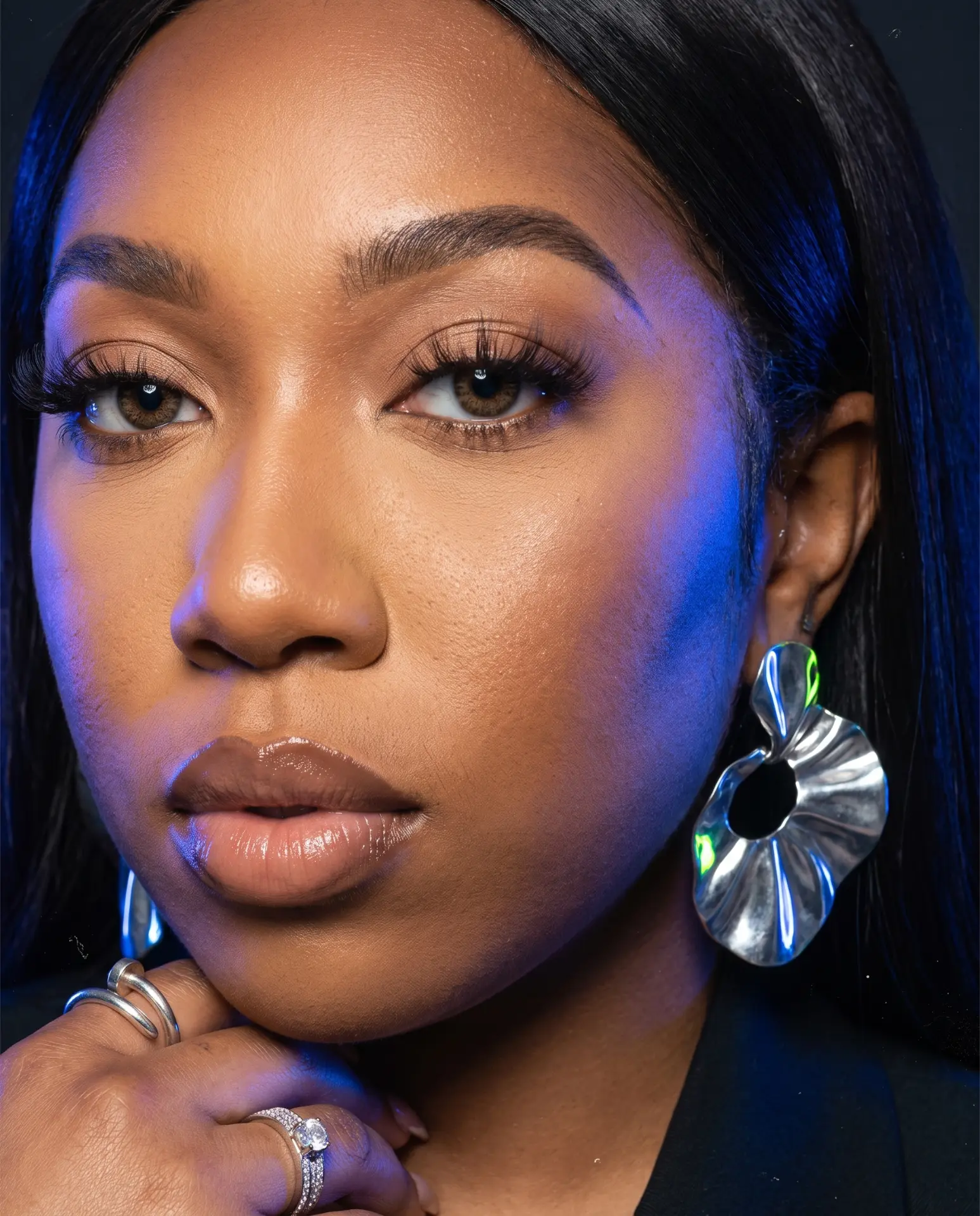 Close-up editorial portrait of Kendah Parris with cobalt rim lighting.